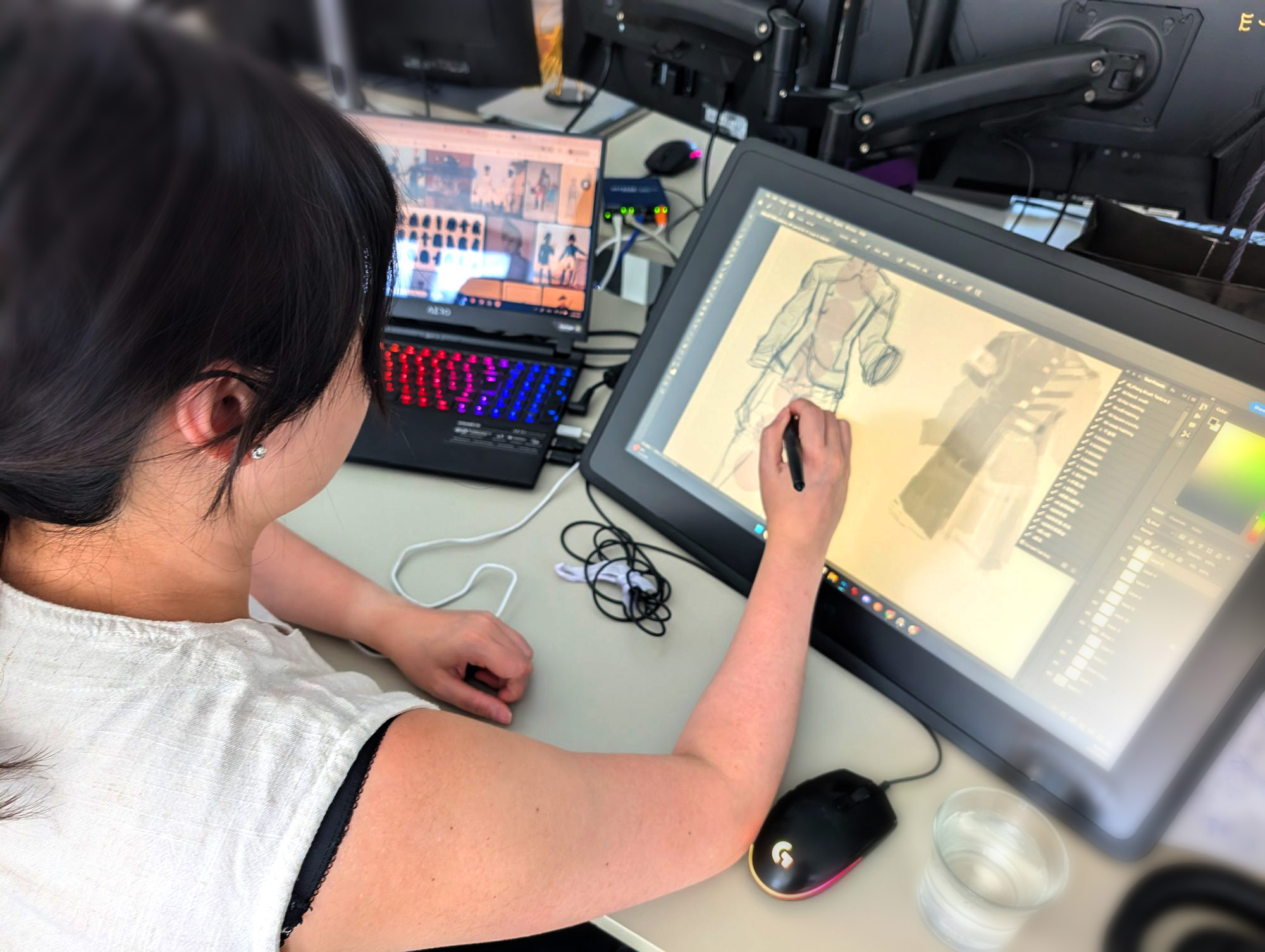 An Equinox artist sketching concept art on a drawing tablet